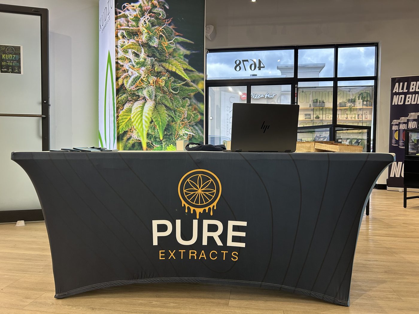 Pure Extracts branded display table at All Love Dispensary
