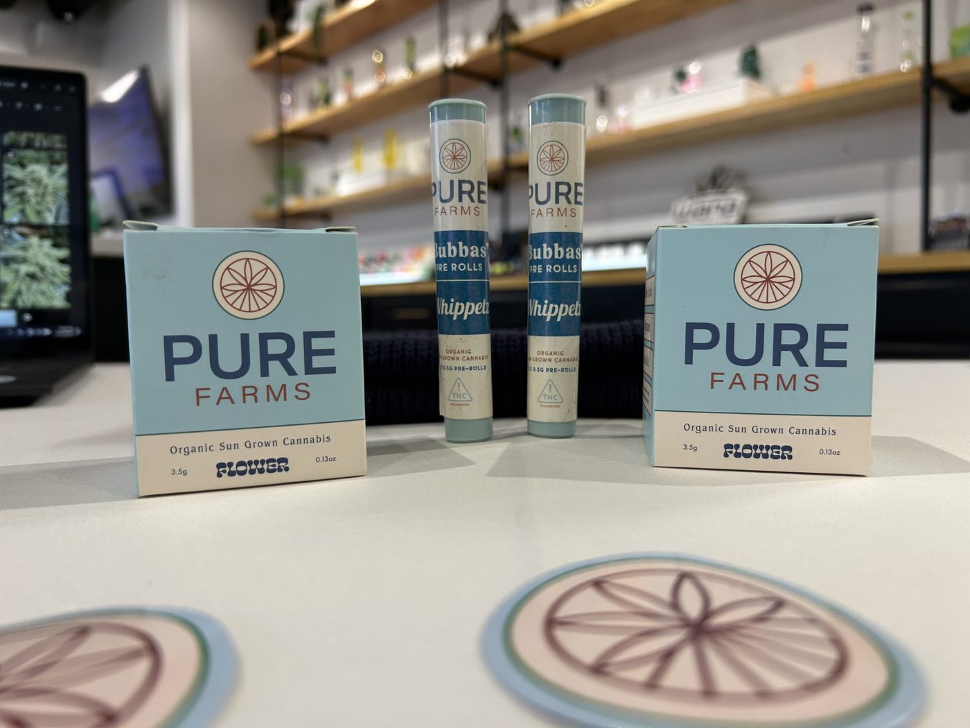 Pure Mississippi Farms 3.5g flower boxes and pre-roll tubes on a dispensary counter